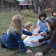 children pet a turkey at the Thanksgiving for the Turkeys event at Poplat Springs Animal Sanctuary